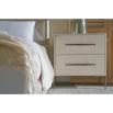 White wooden bedside table with textured cast metal base