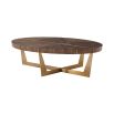 A contemporary coffee table by Theodore Alexander with an oval shape and brass finished base