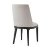 A sophisticated dining chair with a grey upholstery, plush seat and dark tapered legs