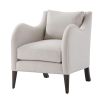 A stylish armchair with a grey upholstery, chic curves and wavy armrests 