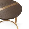 A glamorous side table with a round, veneered top and brushed brass base