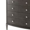 A tall chest of drawers with a luxury design featuring embossed leather, tapered legs and polished nickel adornments