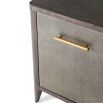 A luxurious chest with three textured drawers covered in embossed leather and finished with brushed brass handles