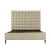 A modern bed with a soft and padded, deep buttoned back and upholstered cream finish 