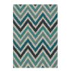 Hand-tufted wool rug with chevron pattern in teal