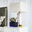 A glamorous solid marble table lamp with polished brass accents