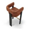 A luxury bar stool with a striking vibrant upholstery and brass detailing