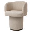 A stylish dining chair with a luxury beige upholstery and unique silhouette