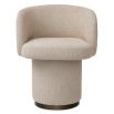 A stylish dining chair with a luxury beige upholstery and unique silhouette