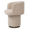 A stylish dining chair with a luxury beige upholstery and unique silhouette