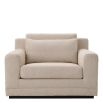 A sophisticated armchair with a luxury beige upholstery