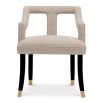 A stylish dining chair with a distinctive silhouette and luxury beige upholstery