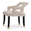 A stylish dining chair with a distinctive silhouette and luxury beige upholstery