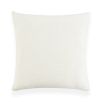 White cushion with black wavy shape and two orange circles