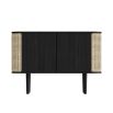 A sophisticated black oak and cane cabinet with rattan detailing