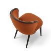 A statement recycled velvet upholstered dining chair with a curved backrest