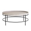 Round coffee table with a black metalwork frame and pale edged top