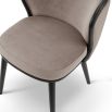 A luxury recycled velvet upholstered dining chair with a curved backrest