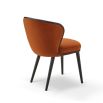 A statement recycled velvet upholstered dining chair with a curved backrest