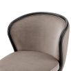 A luxury recycled velvet upholstered dining chair with a curved backrest