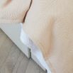 Nude satin finish throw with soft velvet interior