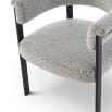 Elegant boucle upholstered dining chair in grey with black frame