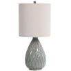 This ceramic table lamp features a textured rust and aqua pattern, brushed nickel accents, and a beige linen shade