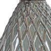 This ceramic table lamp features a textured rust and aqua pattern, brushed nickel accents, and a beige linen shade