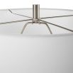 This tapered ceramic lamp has a distressed off-white finish, brushed nickel accents, and a white linen shade, adding timeless elegance to any space.
