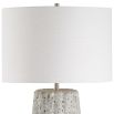 This ceramic lamp features a weathered stone finish, brushed nickel accents, and a soft off-white linen shade, bringing timeless elegance and classic sophistication to any space.