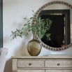 Charming round mirror with rustic elegance