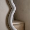 Wall mirror with a wavy edge detailing