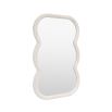Wall mirror with a wavy edge detailing