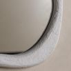 Wall mirror with a wavy concrete-effect frame