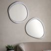 Wall mirror with a wavy concrete-effect frame