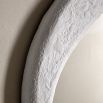 Wall mirror with a wavy concrete-effect frame
