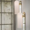 Contemporary solid brass wall lamp in a natural finish with a long translucent glass lampshade