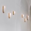 Contemporary solid brass wall lamp in a natural finish with a long translucent glass lampshade