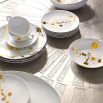 A gorgeous set of four white and speckled gold porcelain plates.