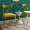 A luxurious vintage style dining chair with polished brass accents