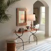 A chic table lamp by Jonathan Adler featuring a sinuous silhouette, stoneware structure, subtle lines, a matte glaze and white paper lampshade