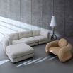 The Pompidou Lounge Chair is a deep, cozy cocoon with a tubular framework, upholstered in Valais Latte bouclé for ultimate comfort.