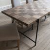 Elegant, industrial-inspired dining table with cubed wood finish and iron legs