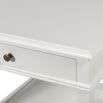 A luxurious, classic white bedside table with a drawer