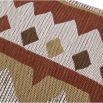 Woven cushion with playful display of geometric design 