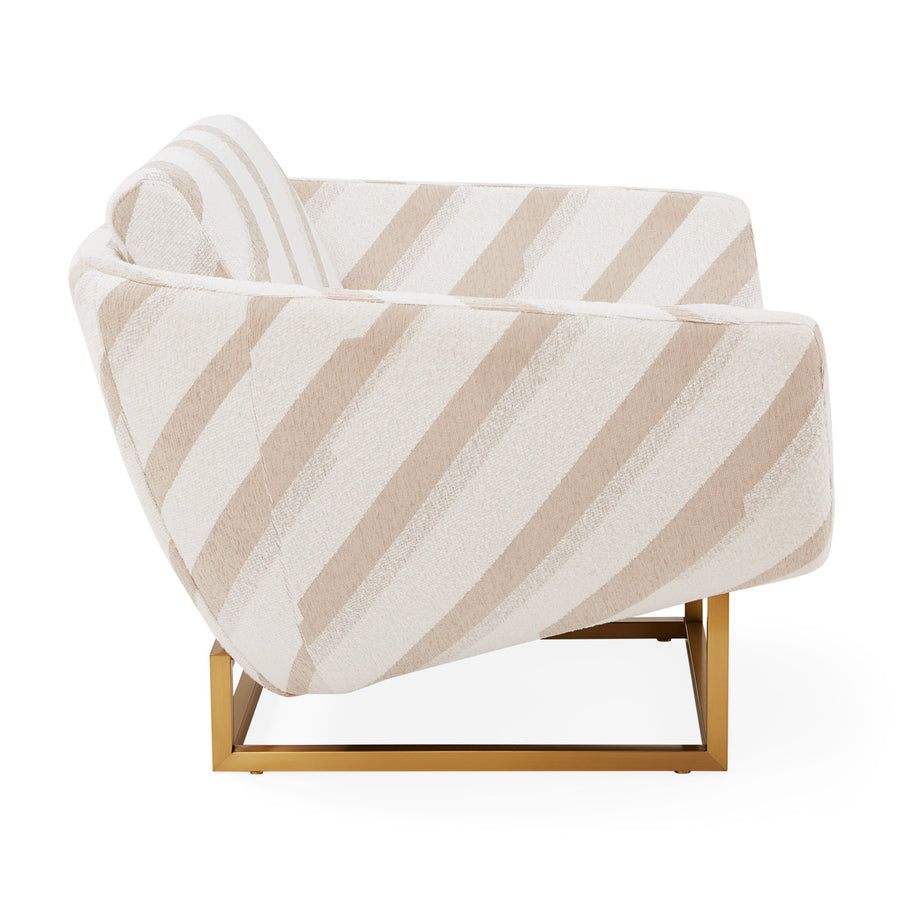 The Beaumont Lounge Chair combines minimalist design with luxurious comfort, featuring a sculptural brass base and elegant upholstery in velvet or bouclé.