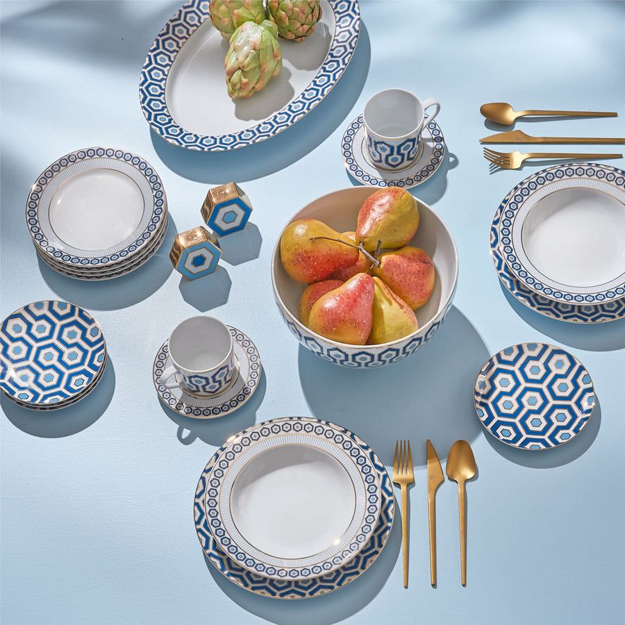 A saucer featuring a signature hexagon pattern in blue and gold, ideal for adding sophistication to your tablescape.