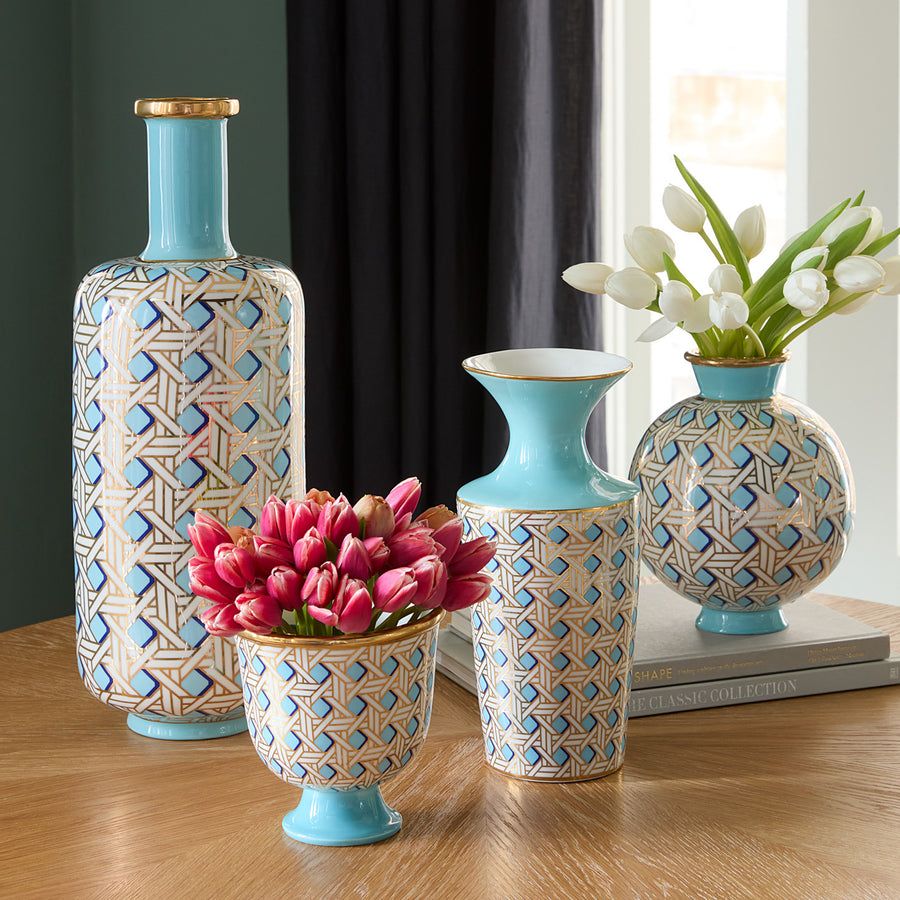 A tall porcelain vase in light blue with gold Palm Beach-inspired caning, blending timeless charm with modern sophistication.