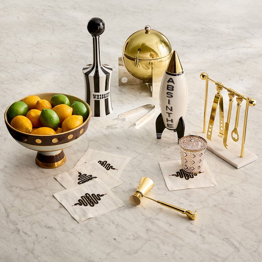 The Absinthe Rocket Decanter is a Space Age porcelain piece with real gold luster and Soviet-inspired typography for a standout bar accessory.