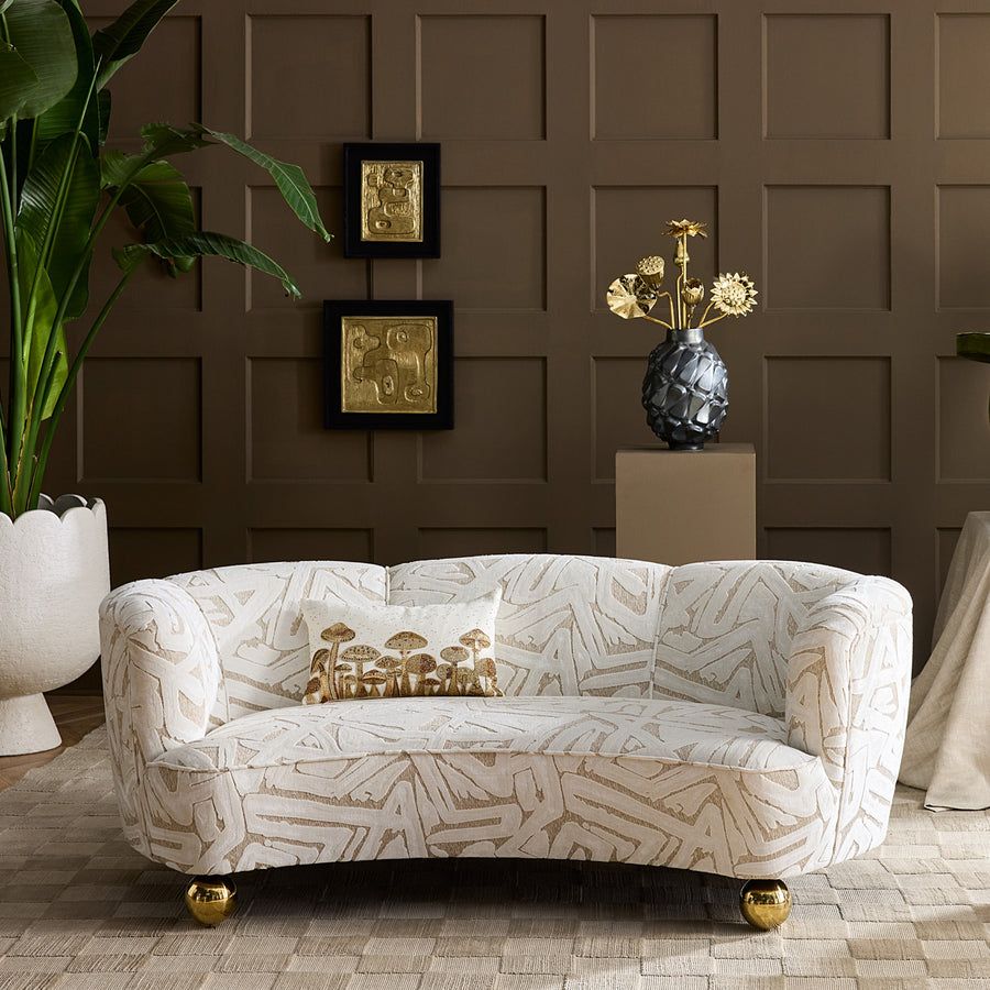 The Botanist Pillow features shimmering gold bead embroidery on white linen, adding natural luxury to any eclectic décor.